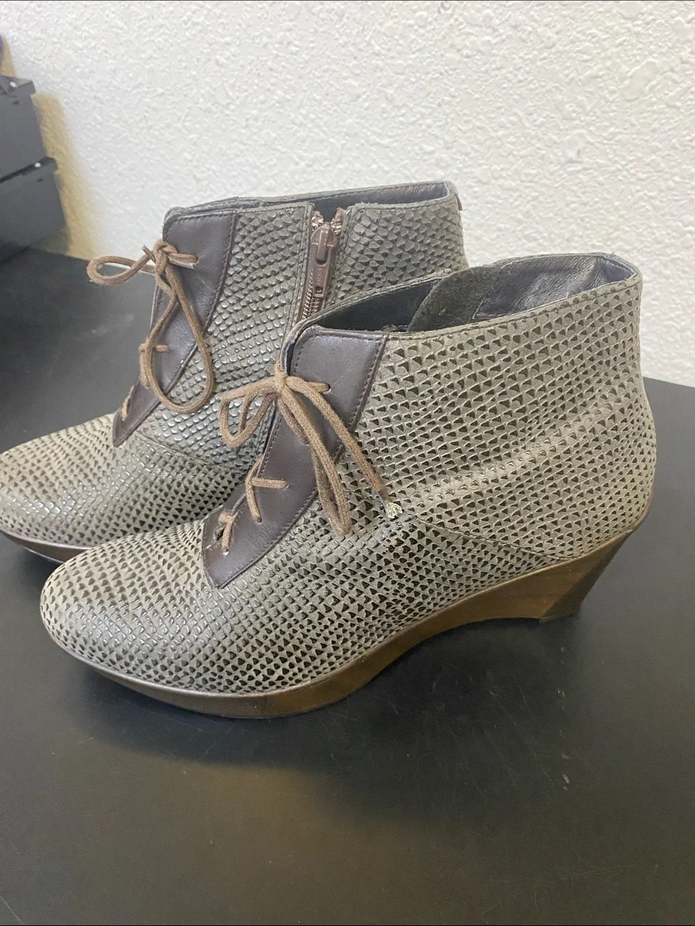 The boots in the image are the Naot Nadine Wedge Bootie,